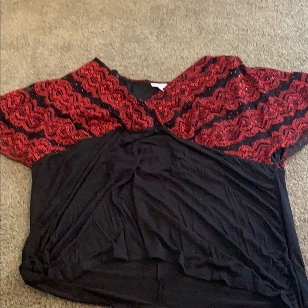A black blouse  and red sequin upper area